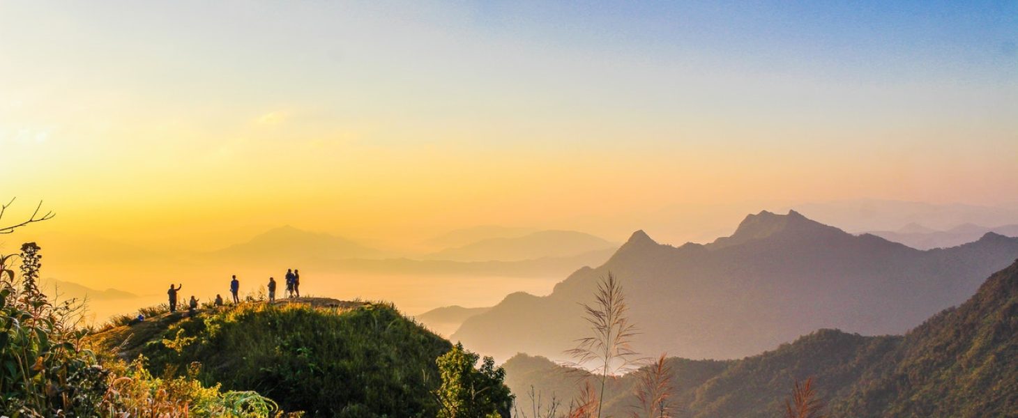 photo-of-people-standing-on-top-of-mountain-near-grasses-733162.jpg